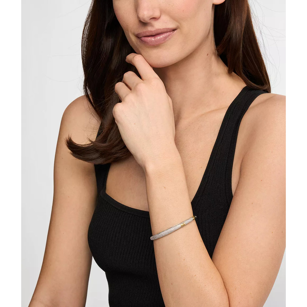 Michael Kors pave bangle bracelet worn on a woman's wrist