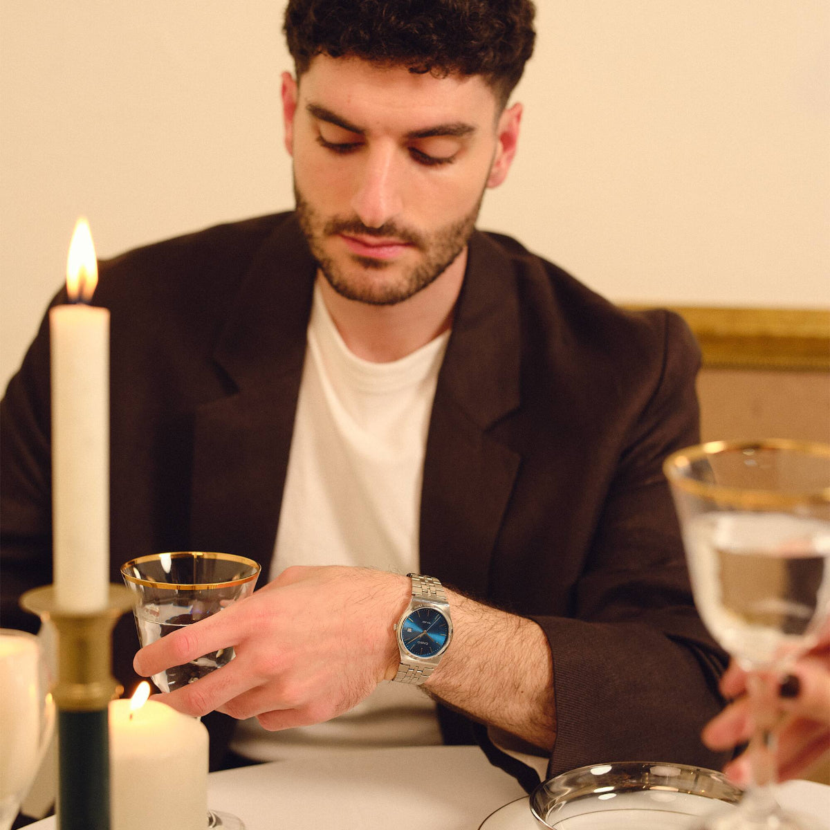 Casio MTP Collection MTP-B145D-2A2VEF blue dial steel watch worn at a candlelit dinner table