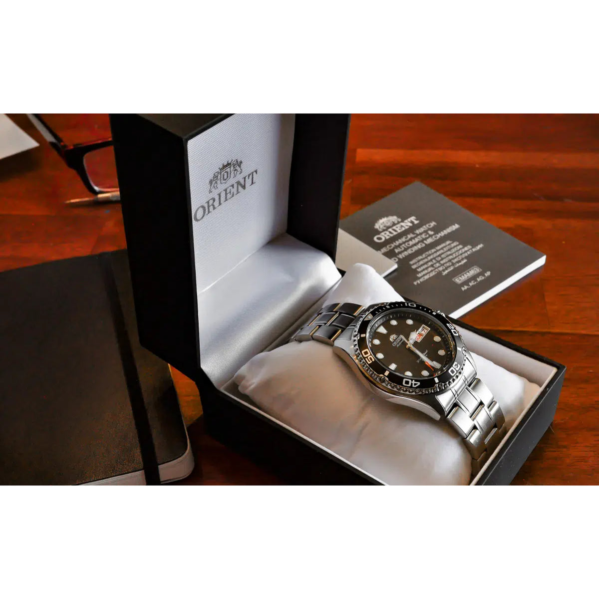 Men's automatic wristwatch with black dial and stainless steel bracelet in a box