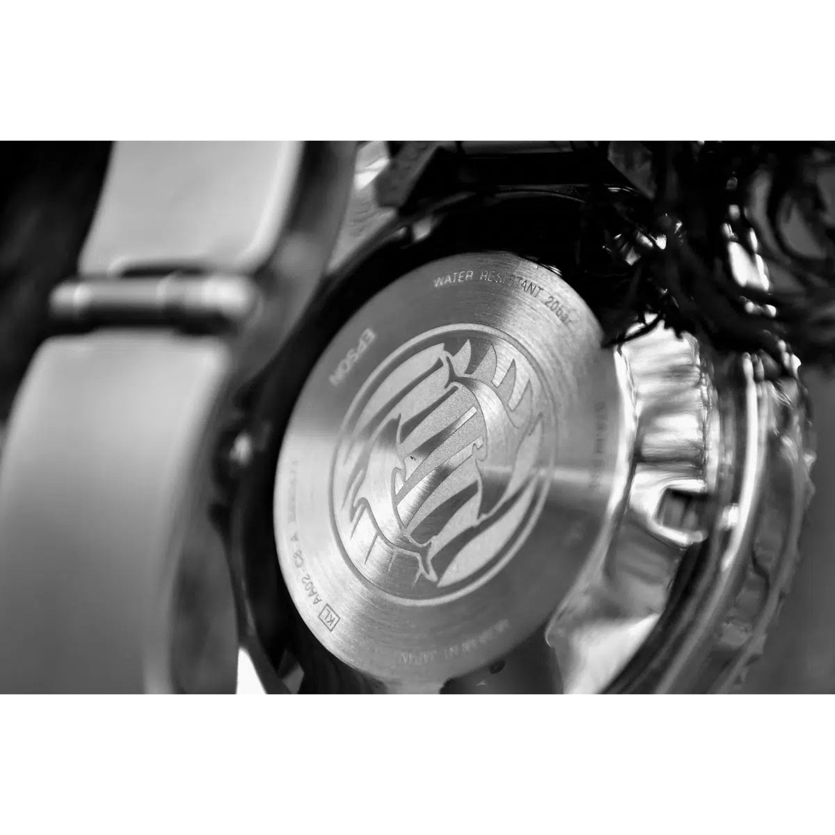 Men's automatic wristwatch caseback with engraved emblem on stainless steel back