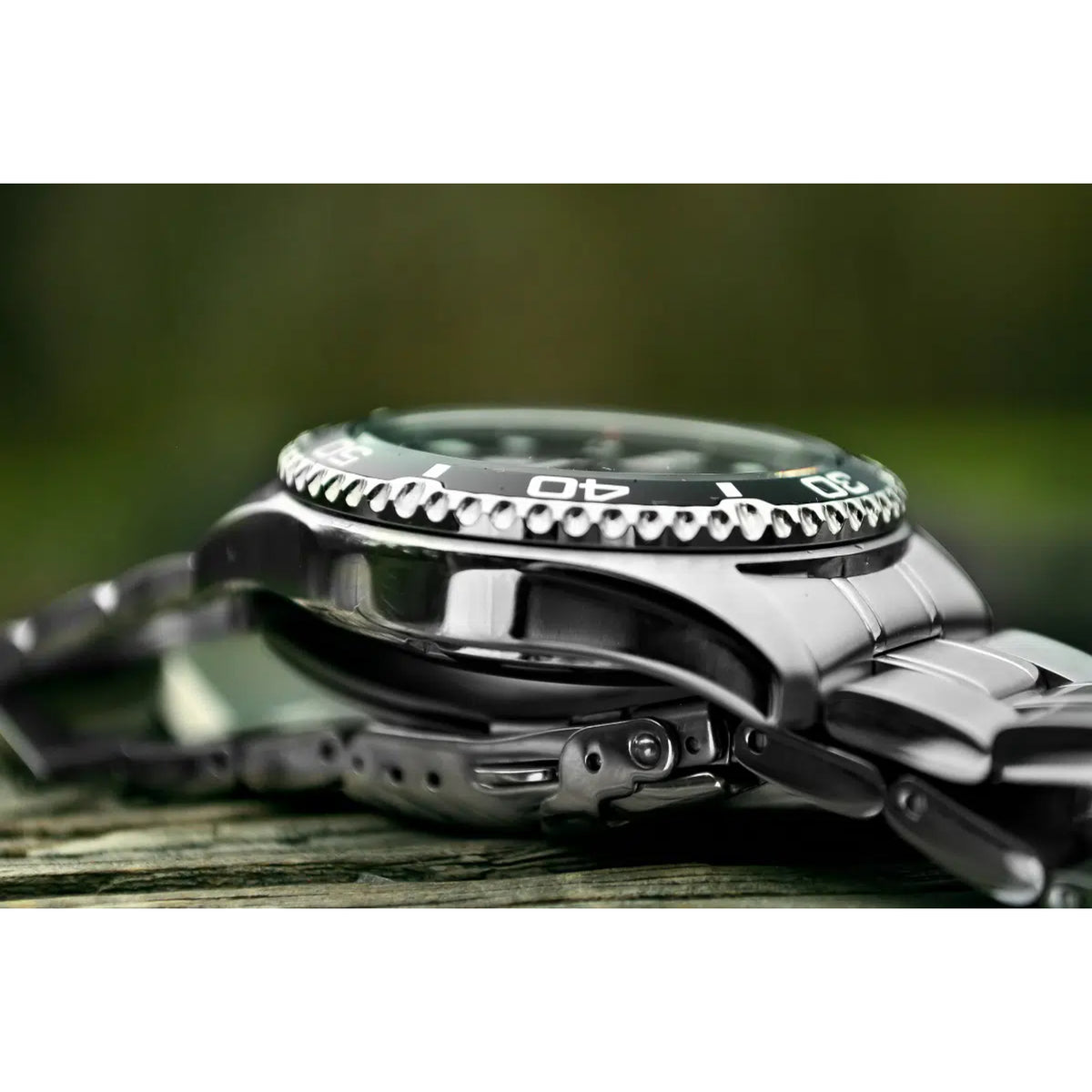 Men's automatic wristwatch side view with stainless steel bezel and crown