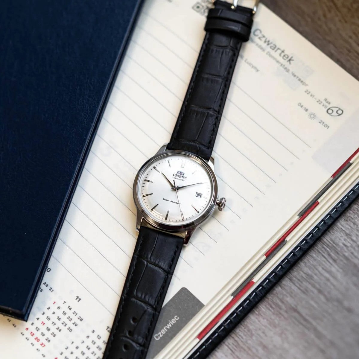 Orient Bambino RA-AC0M03S30B automatic wrist watch with black leather strap and white dial, date window visible