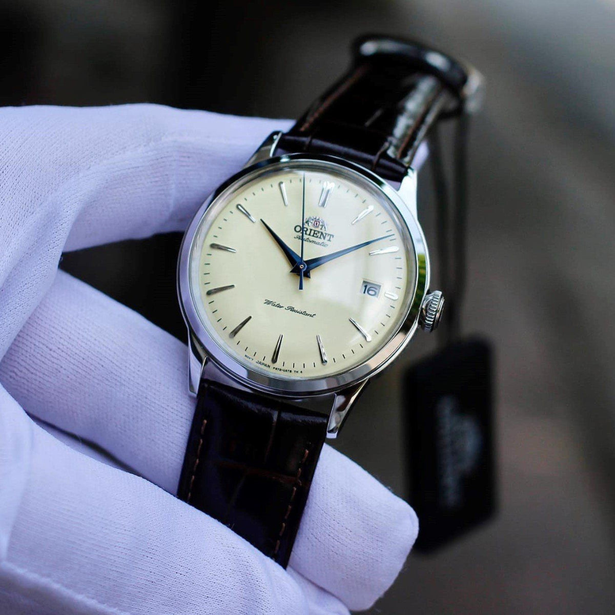 Orient Bambino RA-AC0M04Y30B mens automatic watch with champagne dial and date, brown leather strap