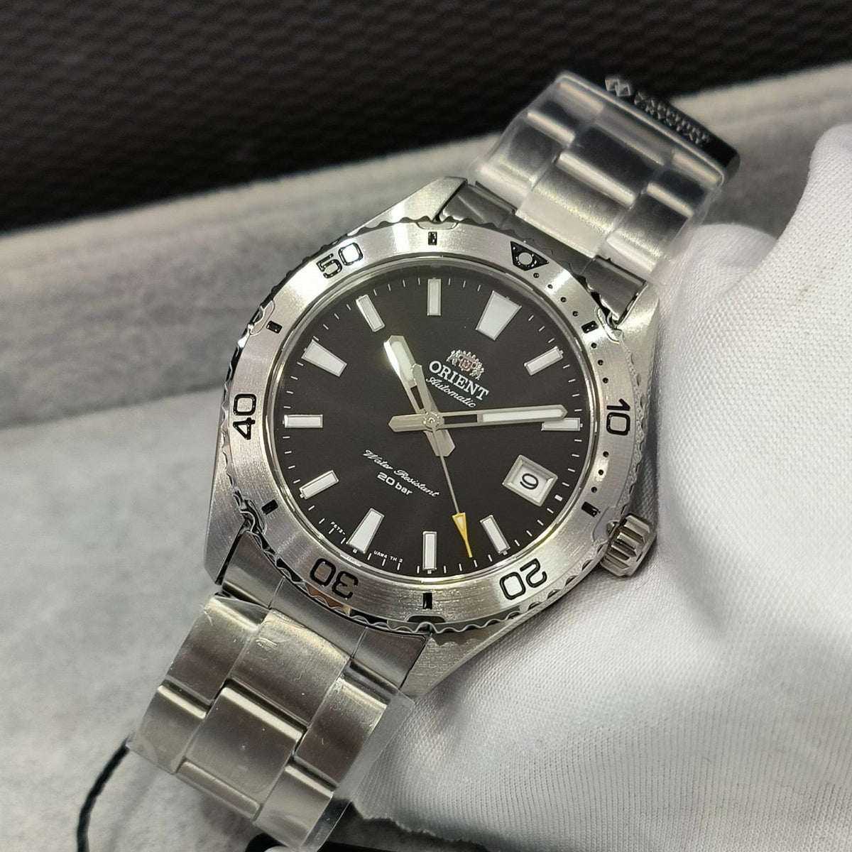Angled front view of Orient Mako RA-AC0Q01B30B black dial automatic watch on display cushion