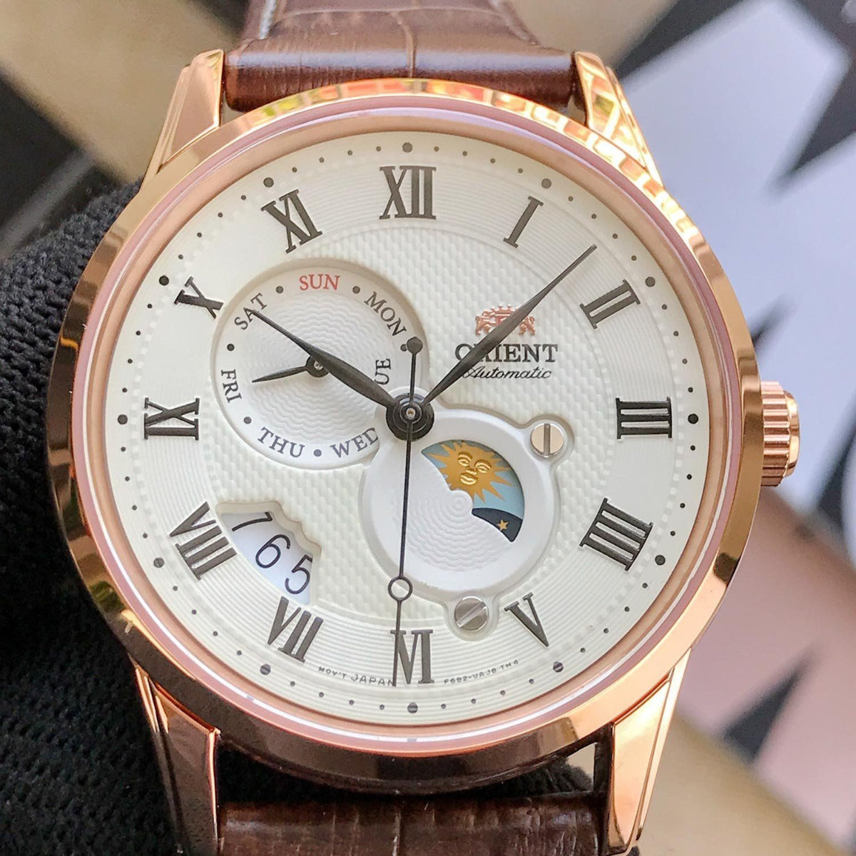 Front view of Orient Bambino Sun & Moon RA-AK0007S30B mens watch showing textured champagne dial and subdials