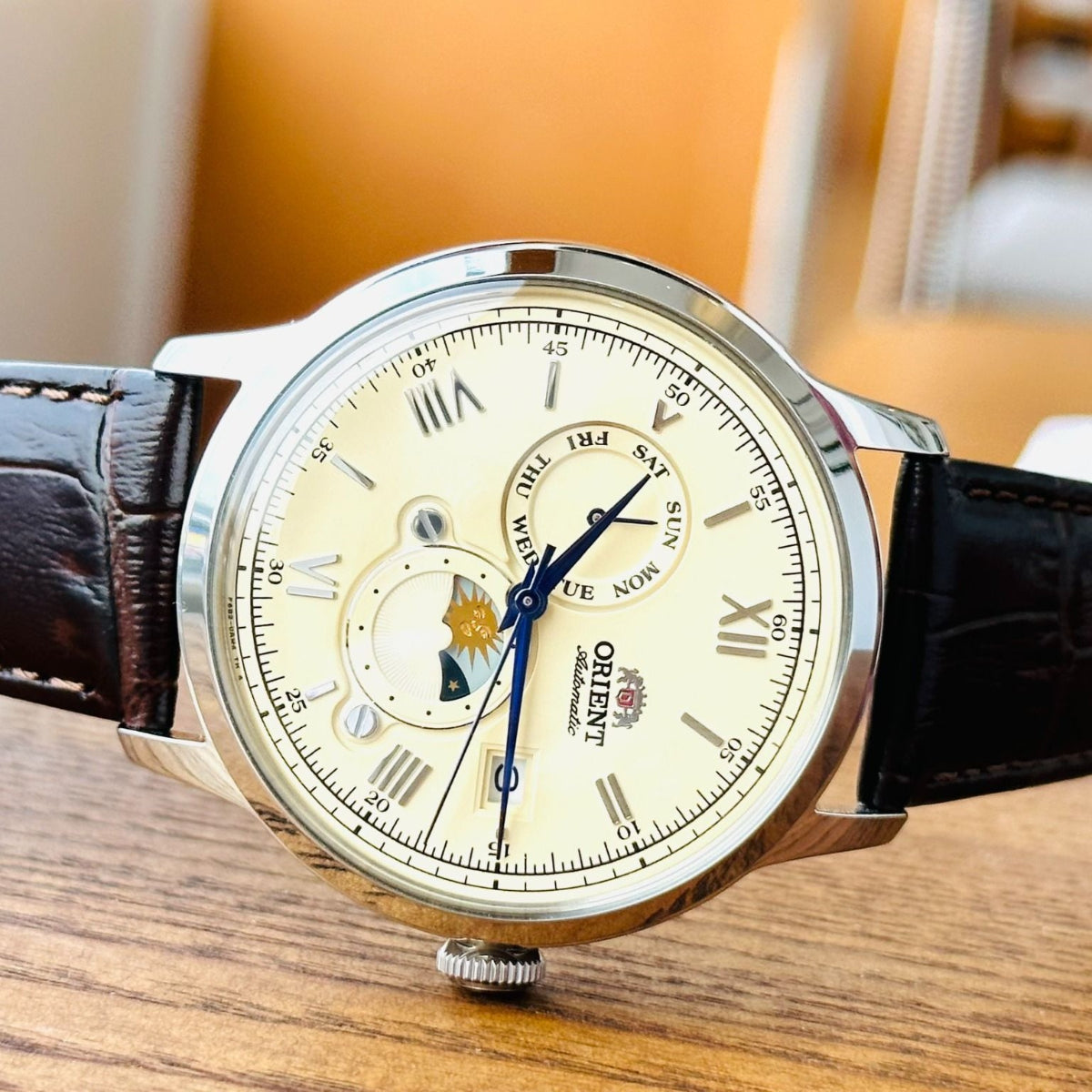 Orient Automatic Sun and Moon angled profile view on wooden surface