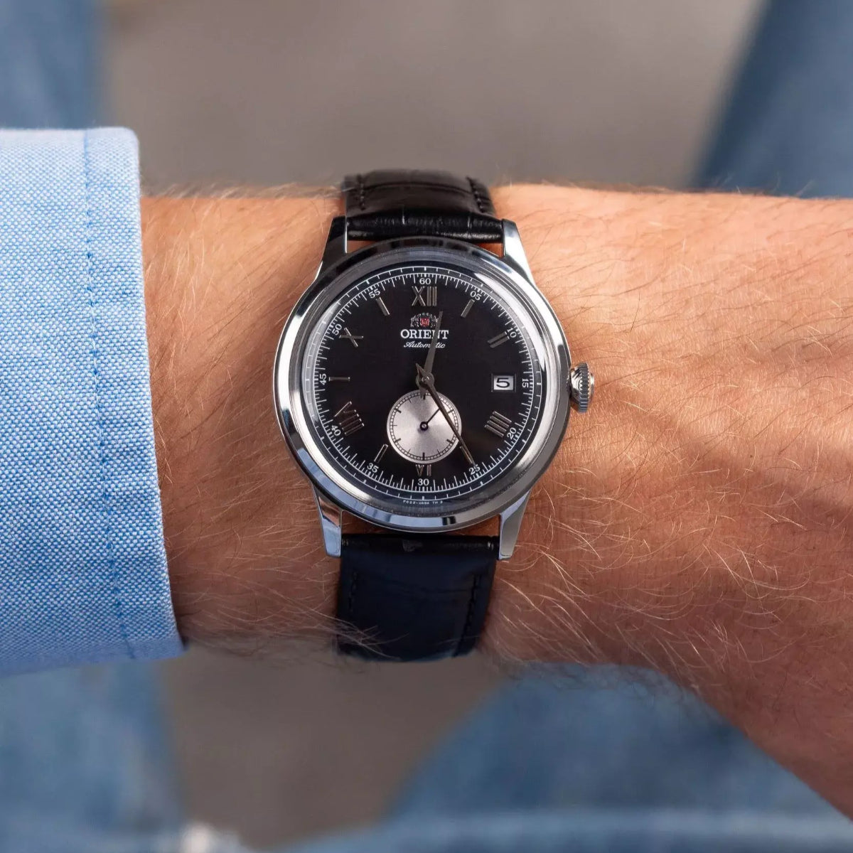 Orient Bambino Version 2 automatic watch AP0101B30B on wrist, black dial with small-seconds subdial, leather strap 