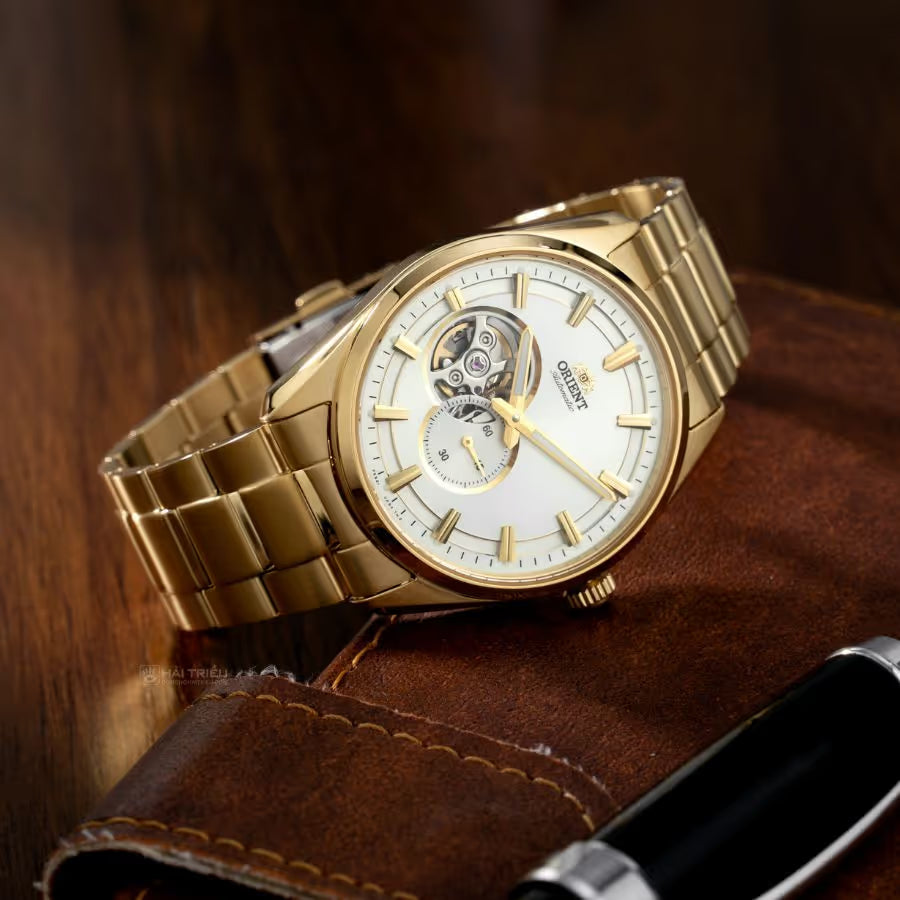 Orient open-heart automatic watch in full gold-tone stainless steel with an exposed balance wheel dial display