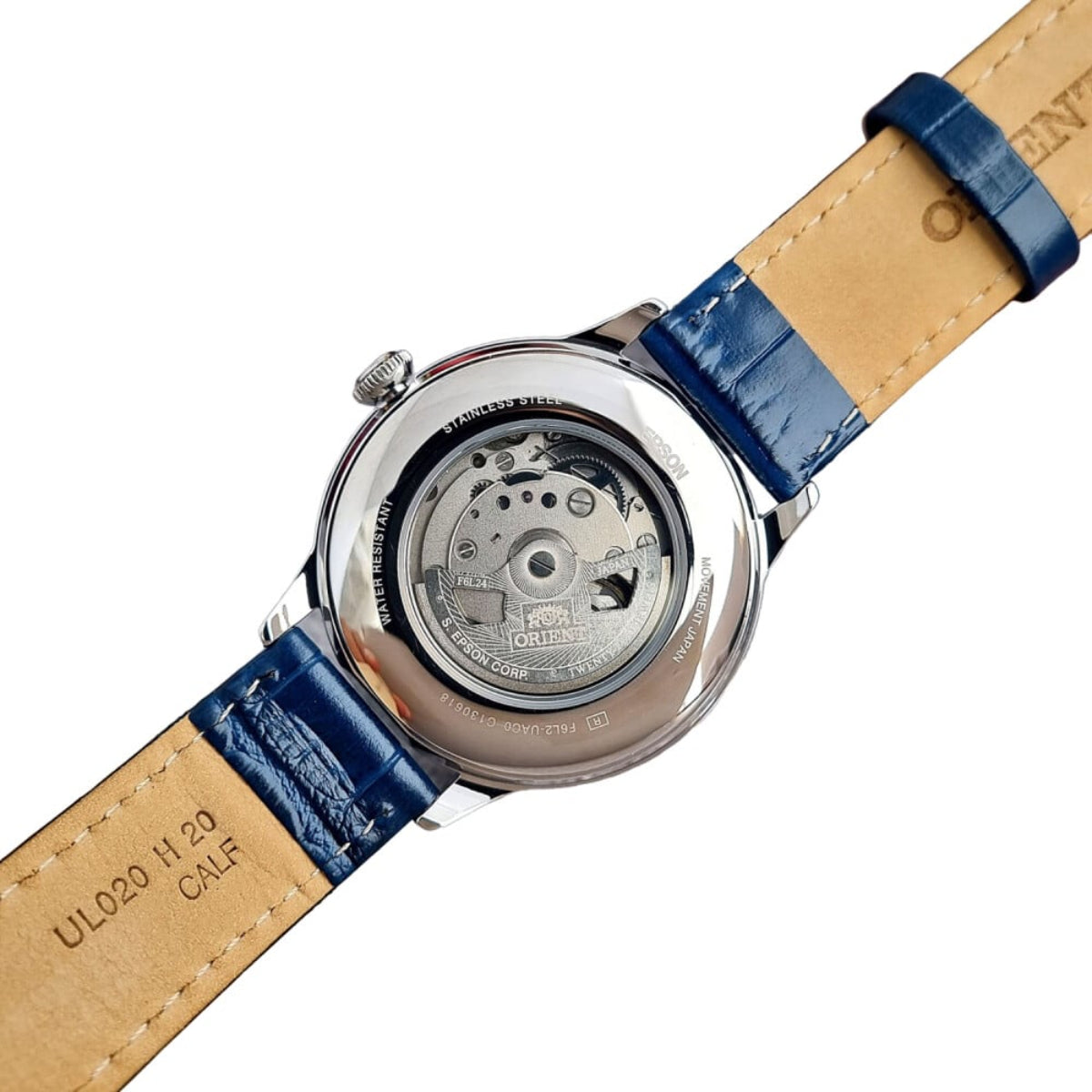 Men's automatic watch case back with blue leather strap and engraved movement