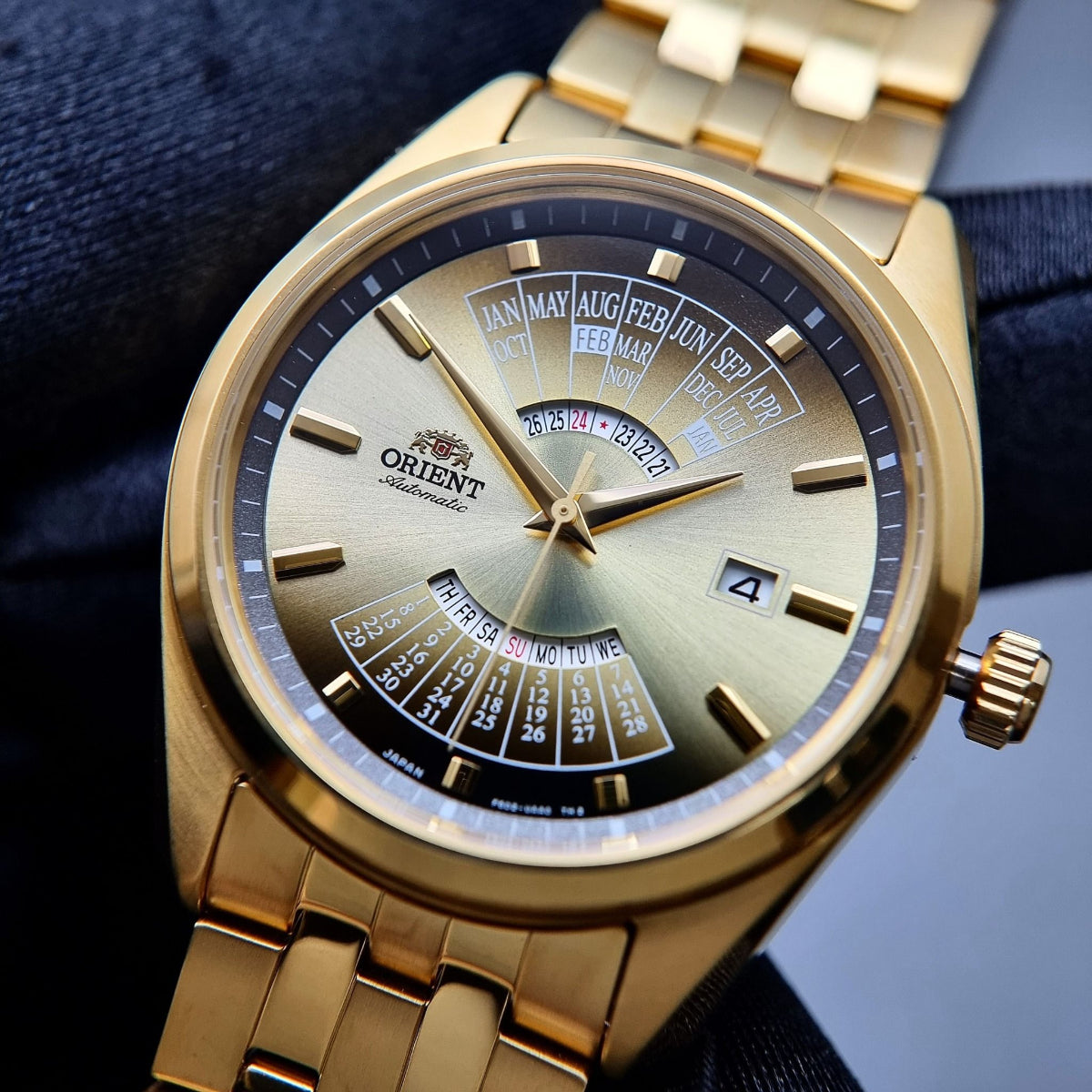 Gold-tone Orient Multi-Year Calendar RA-BA0001G30B wristwatch with sunburst dial, calendar window, and steel bracelet