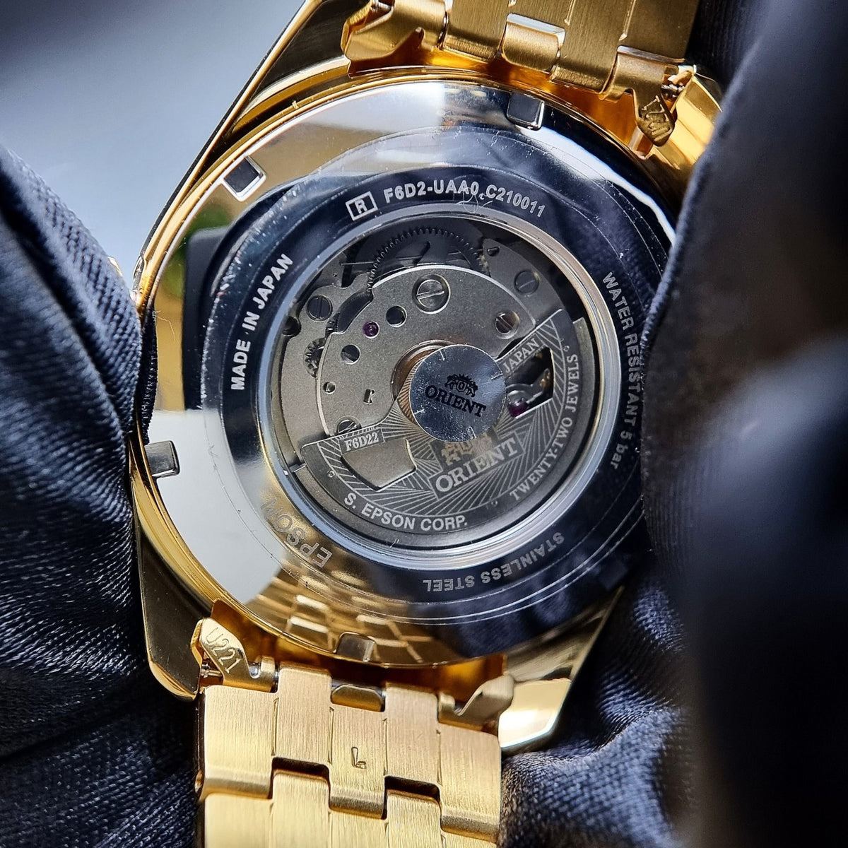 Orient Multi-Year Calendar RA-BA0001G30B automatic watch caseback view with engraved movement and gold-tone stainless steel bracelet