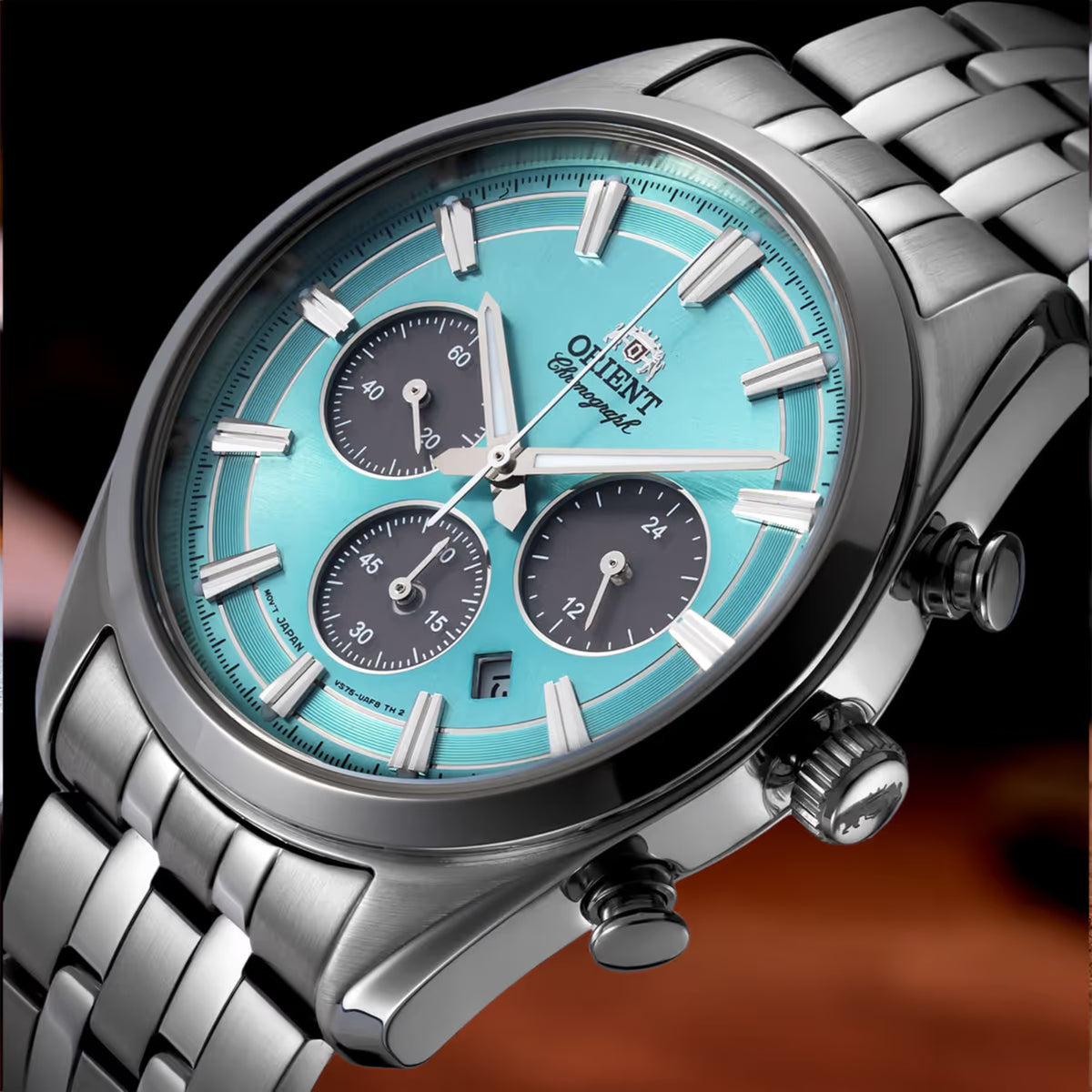 Close-up of solar chronograph watch blue dial with silver hands and three black subdials.