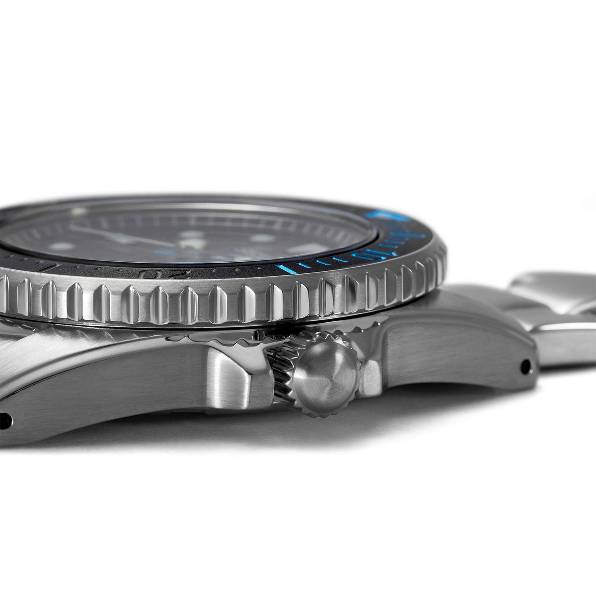 Stainless steel watch case side with ridged bezel edge and crown detail