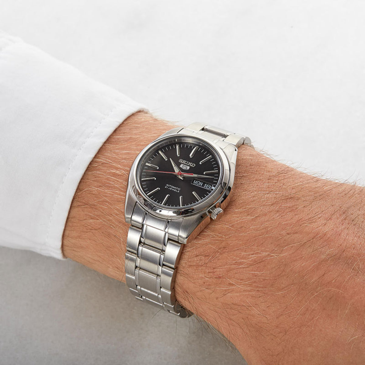 Seiko 5 SNKL45K1 38mm black dial and steel bracelet watch on wrist
