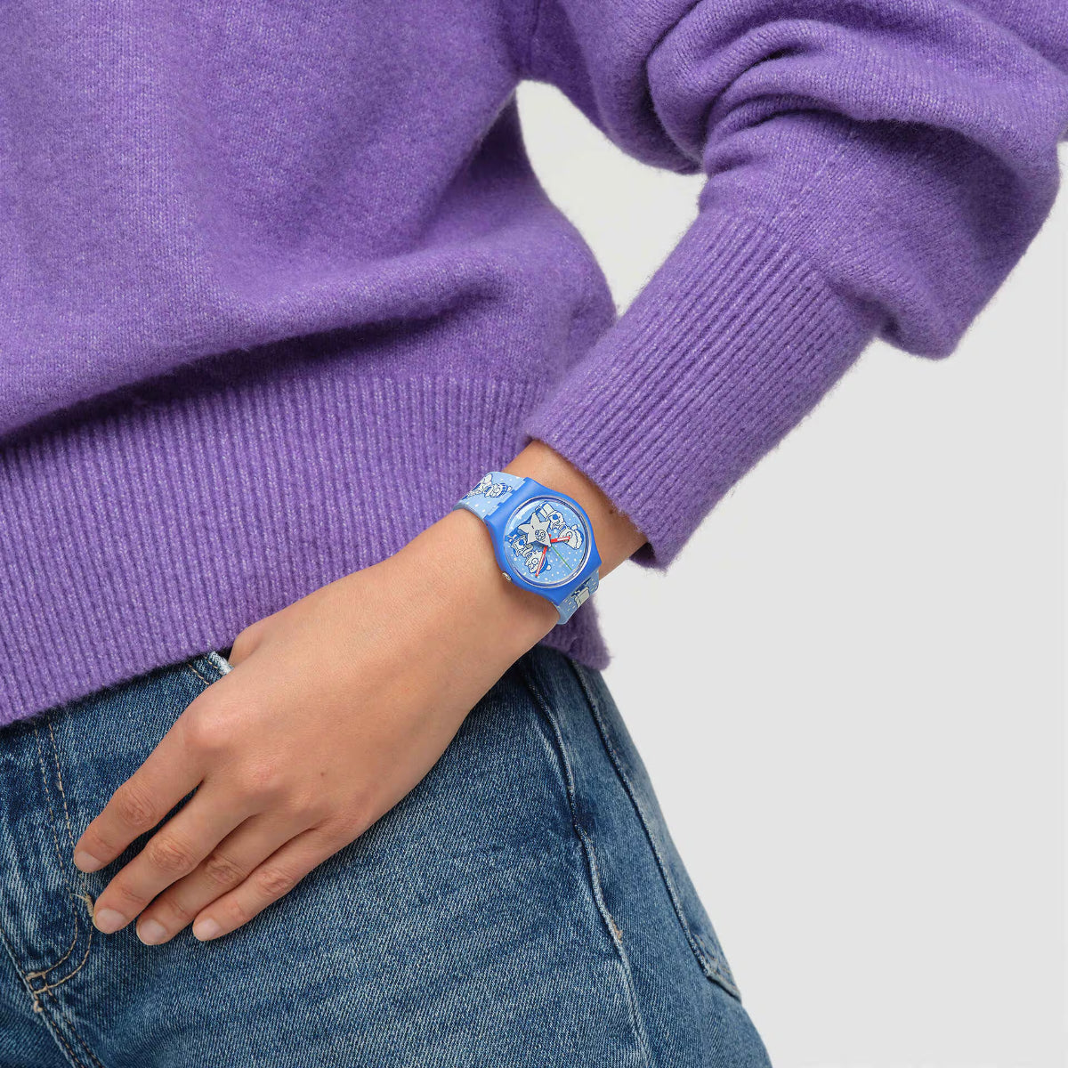 Blue silicone quartz watch on wrist with round blue character dial