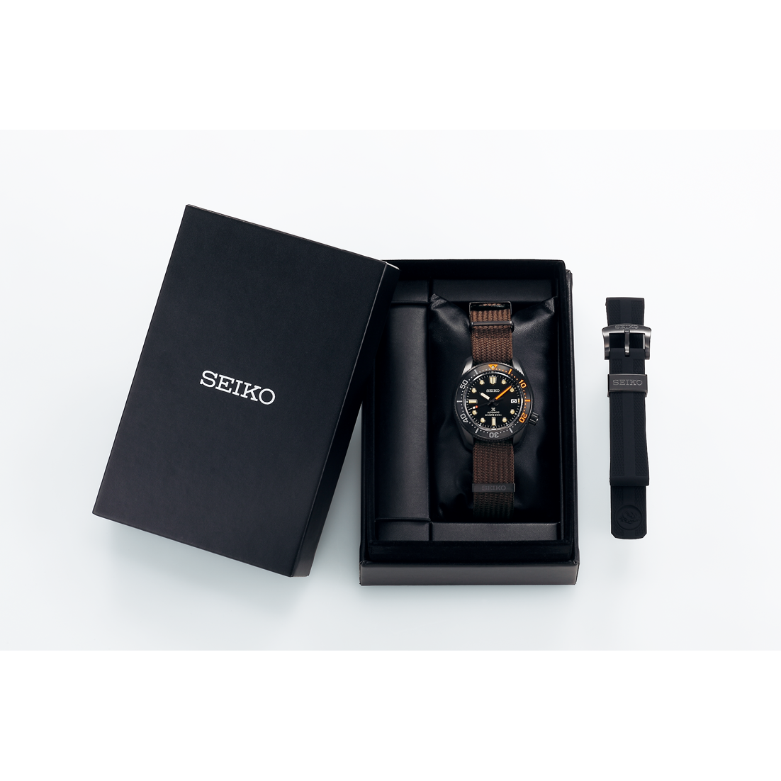 Seiko men's diver watch with brown textile strap in open box with extra strap