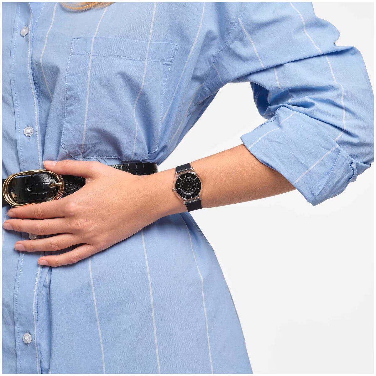 Black dial wristwatch on wrist with black silicone strap and silver case
