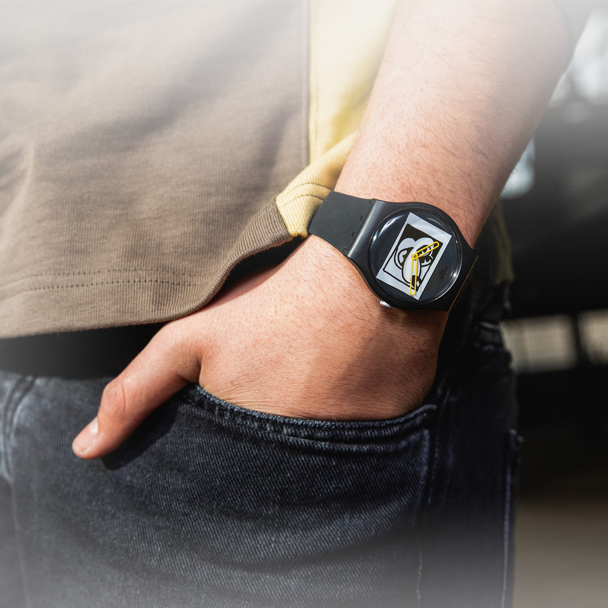 Black silicone quartz watch on wrist with yellow-accent dial