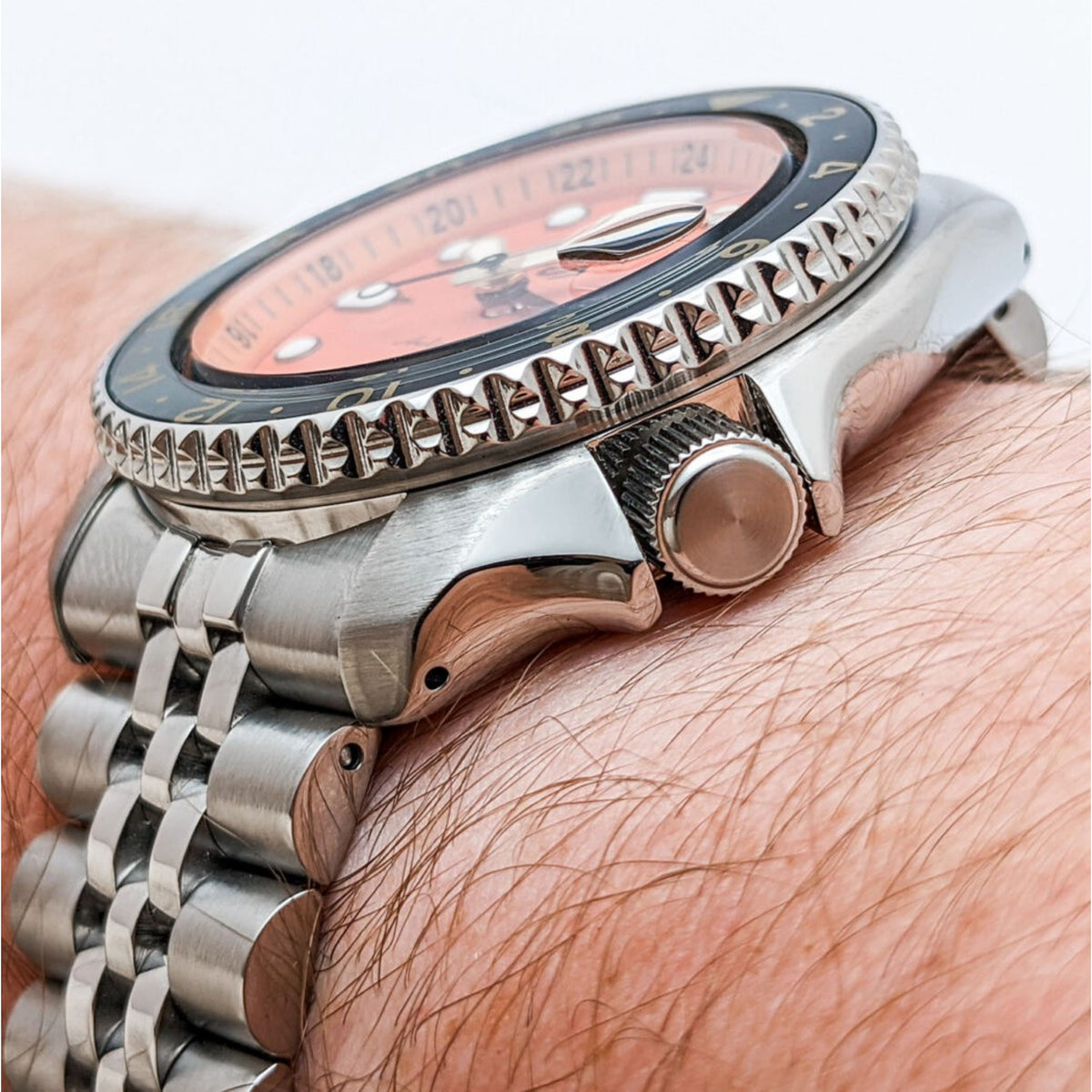 Men's Seiko GMT watch side profile with crown and stainless-steel bracelet