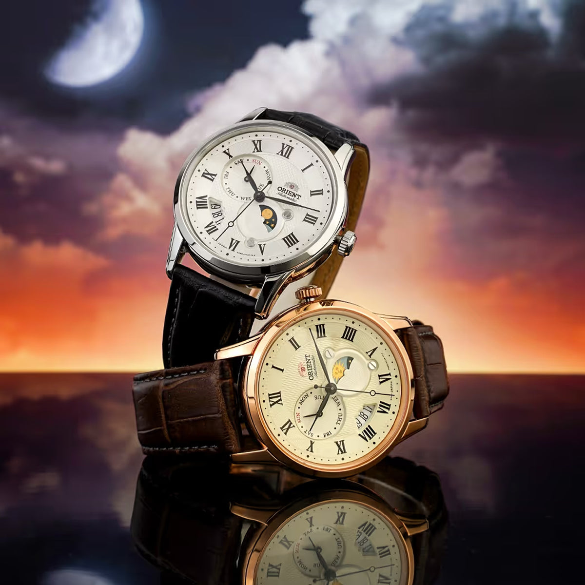 Pair of Orient Sun and Moon automatic watches displaying day-night complication sub-dials and Roman numeral hour markers