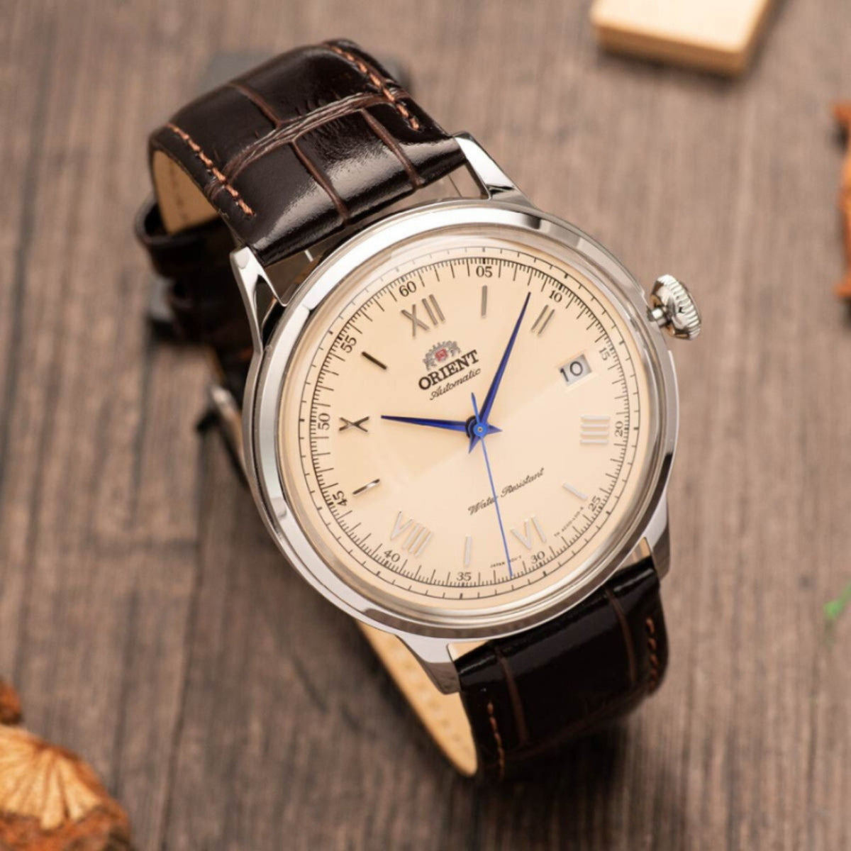 Orient Bambino TAC00009N0 automatic watch with dark leather strap and champagne face, metal crown