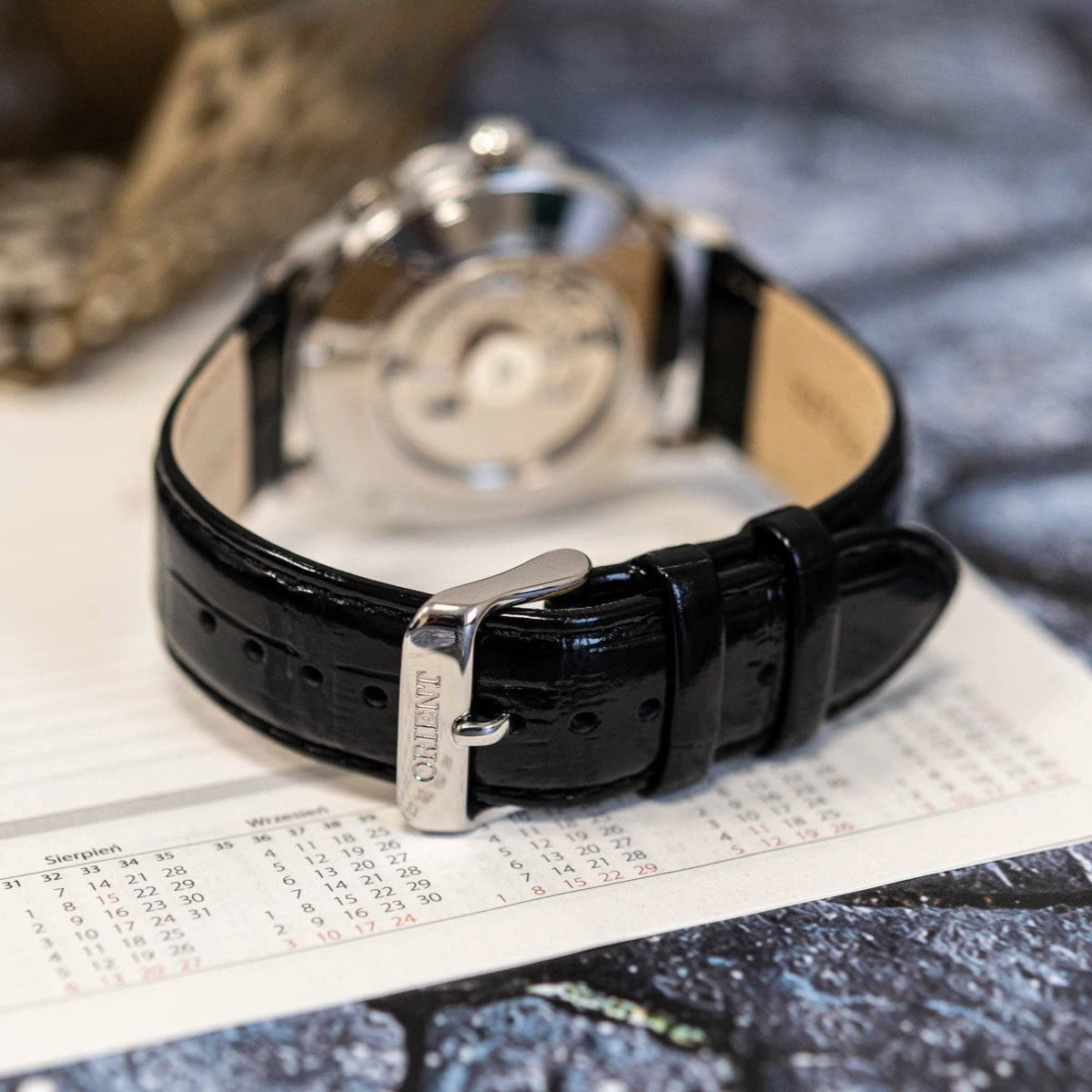 Orient watch with black leather strap and metal buckle clasp