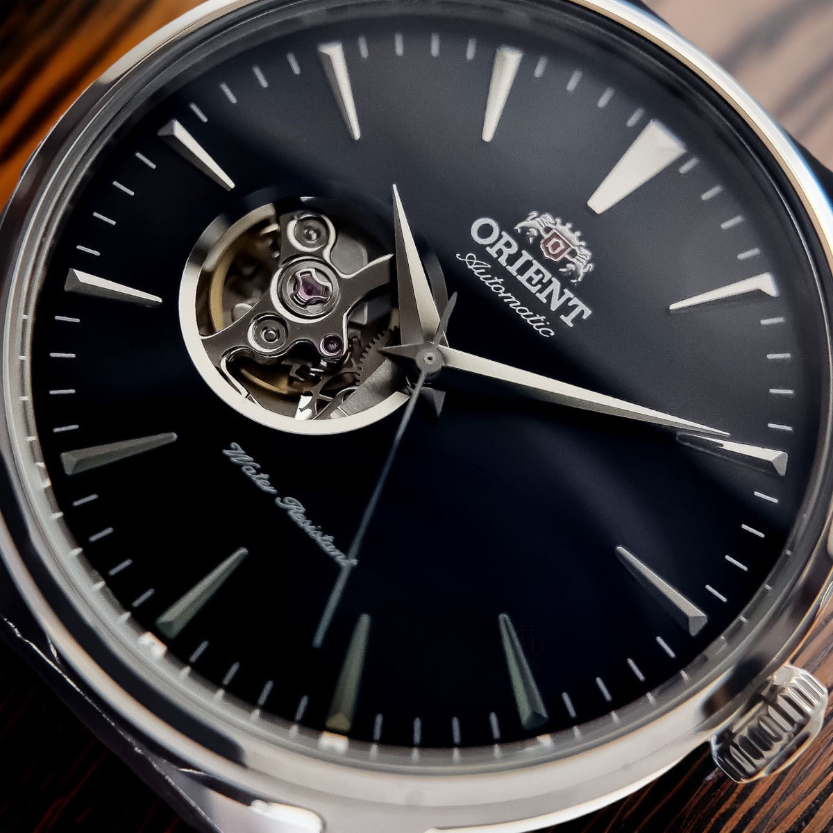 Orient automatic watch dial close-up with open-heart skeleton movement and black face