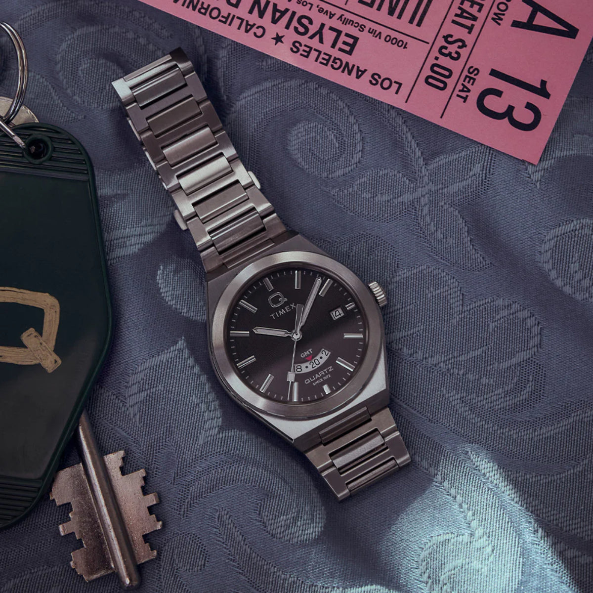 Black dial stainless steel quartz watch with GMT markers and metal link bracelet