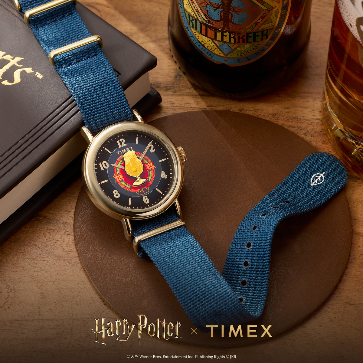 Blue fabric-strapped quartz watch with gold-tone case and blue dial