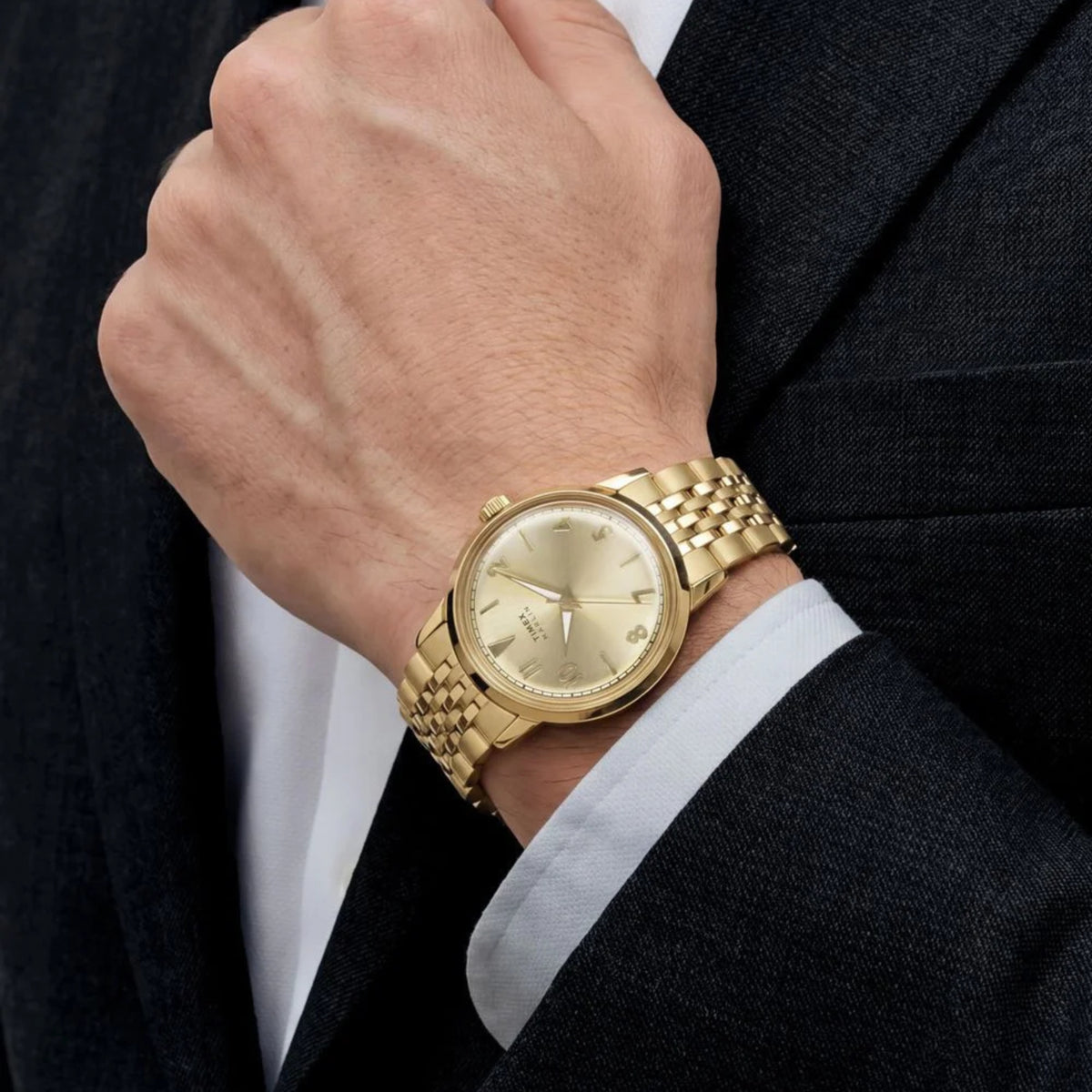 Timex Marlin TW6A04000 wrist view showing champagne dial quartz watch styled on a person wearing a yellow gold-tone steel bracelet