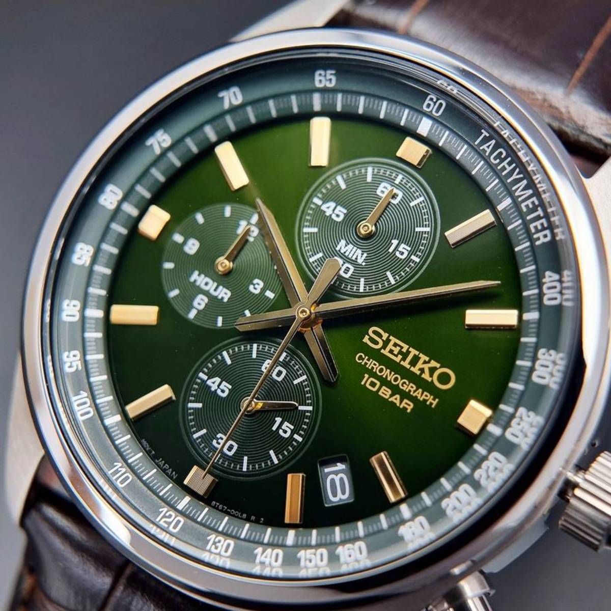 Detailed view of Seiko Essentials SSB385P1 green chronograph dial showing hour markers and date window