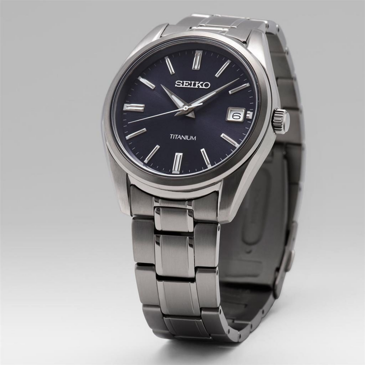 Seiko Essentials SUR373P1 40mm blue dial titanium men's quartz watch full front view on light background