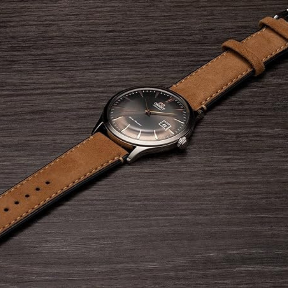Men’s automatic watch on brown leather strap, dark grey dial and silver case