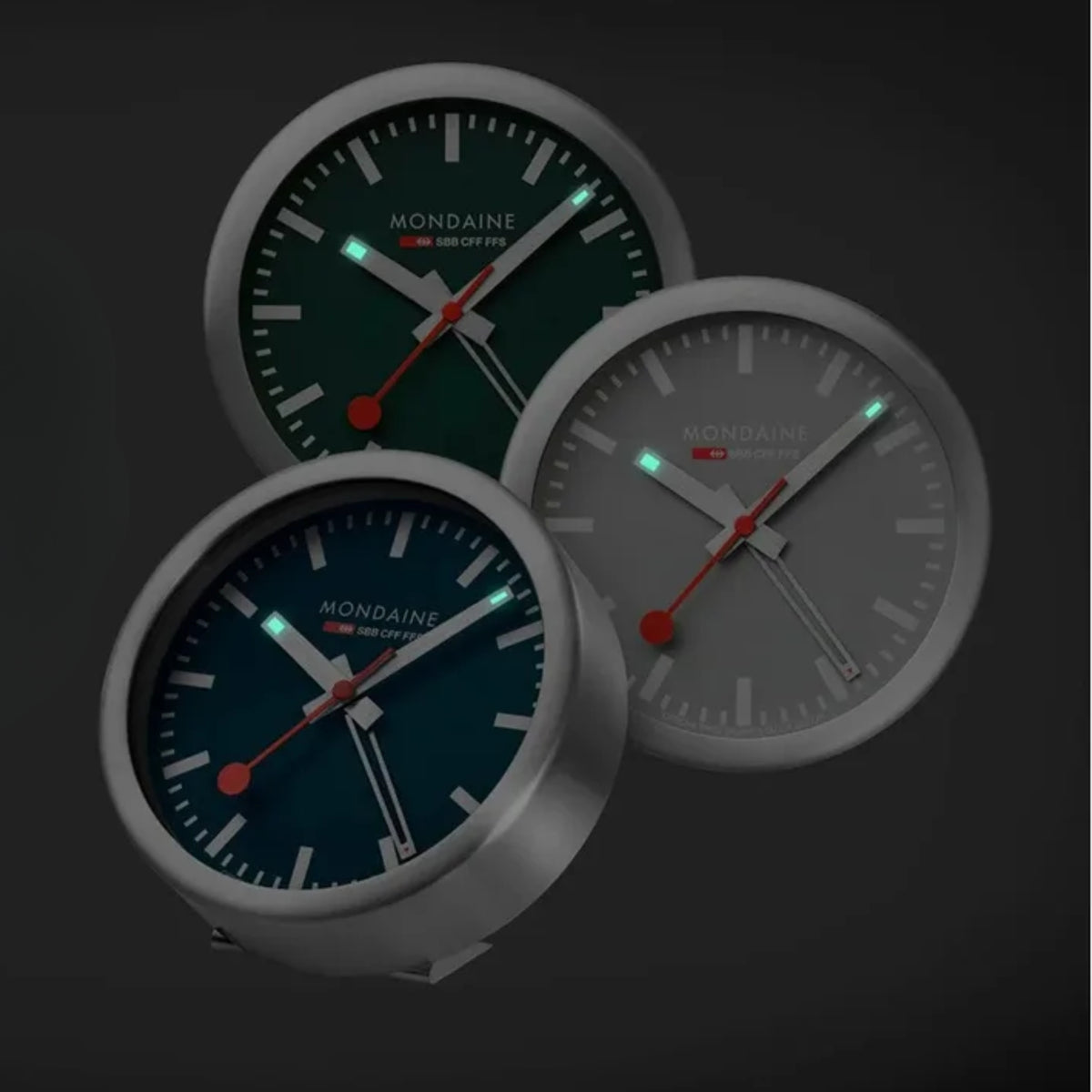 Set of three round alarm clocks with dark teal glowing hour markers and red hands