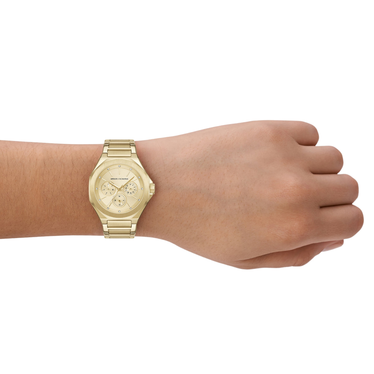 Gold-tone chronograph watch on wrist with champagne dial and three subdials