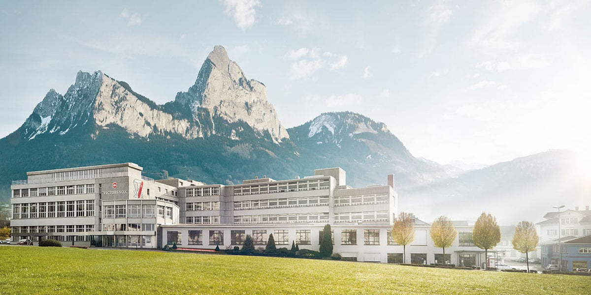Official Victorinox headquarters building in Ibach, Switzerland with Swiss Alps mountains in background
