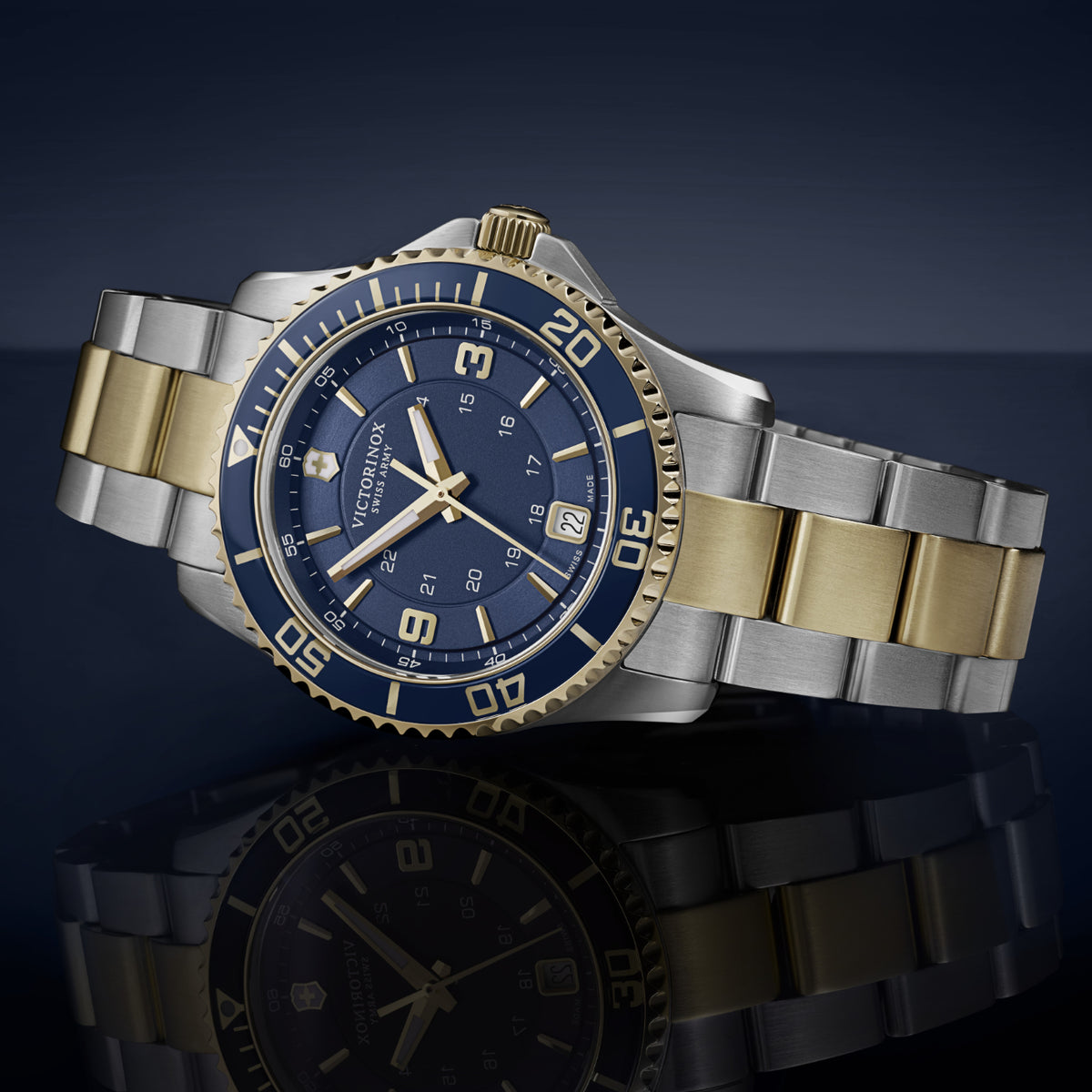 Victorinox Swiss Army two-tone gold and stainless steel diver watch with blue bezel and dial