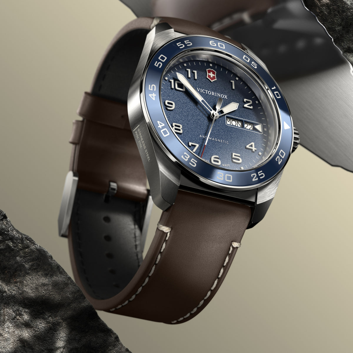 Victorinox anti-magnetic watch with blue bezel, blue dial, and brown leather strap with stitching