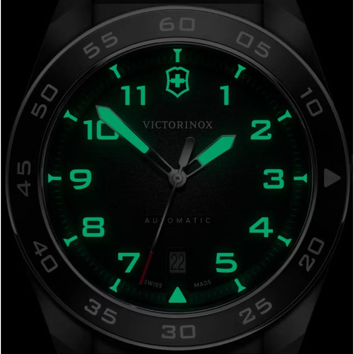 Victorinox Swiss Army automatic watch close-up: black dial with bright green luminous numerals