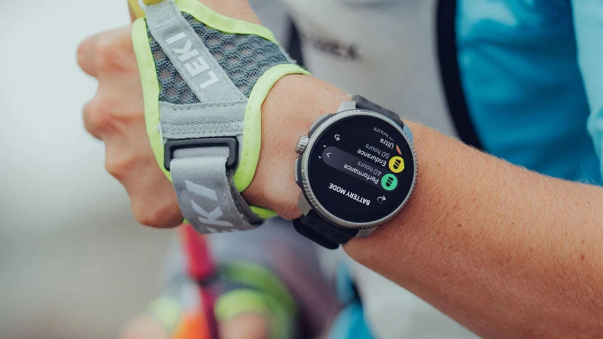 Suunto Race Titanium wrist shot showing battery mode screen on athlete during outdoor training