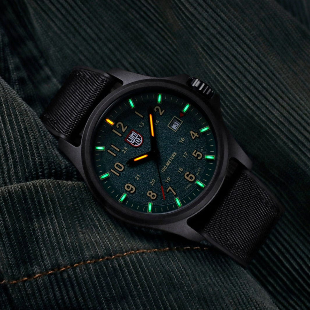 Luminox Atacama Field XL.1977 field watch glowing in the dark, highlighting self-powered tritium light tubes on the hands and dial