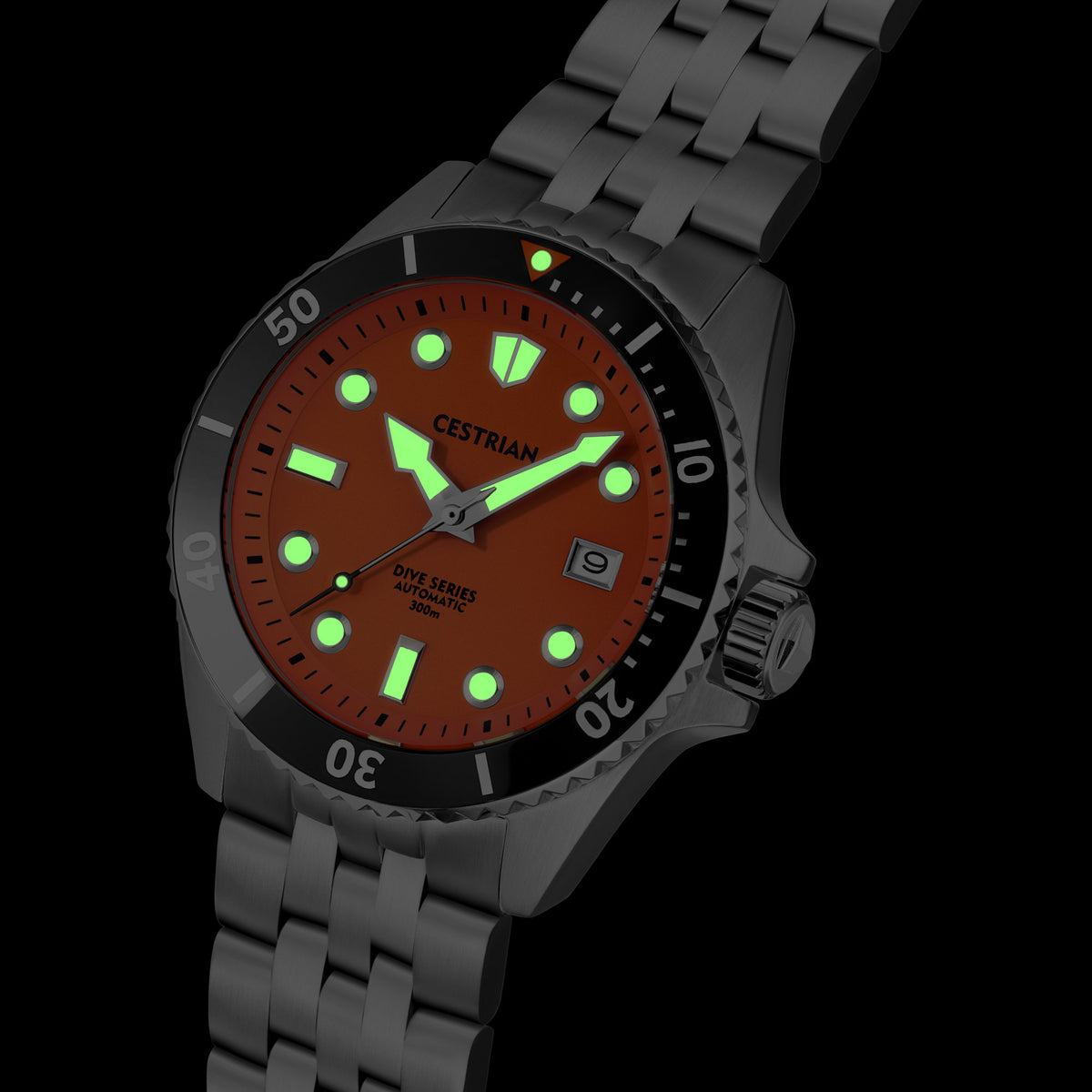 Men's dive watch close-up: orange dial, black bezel, luminous hour markers