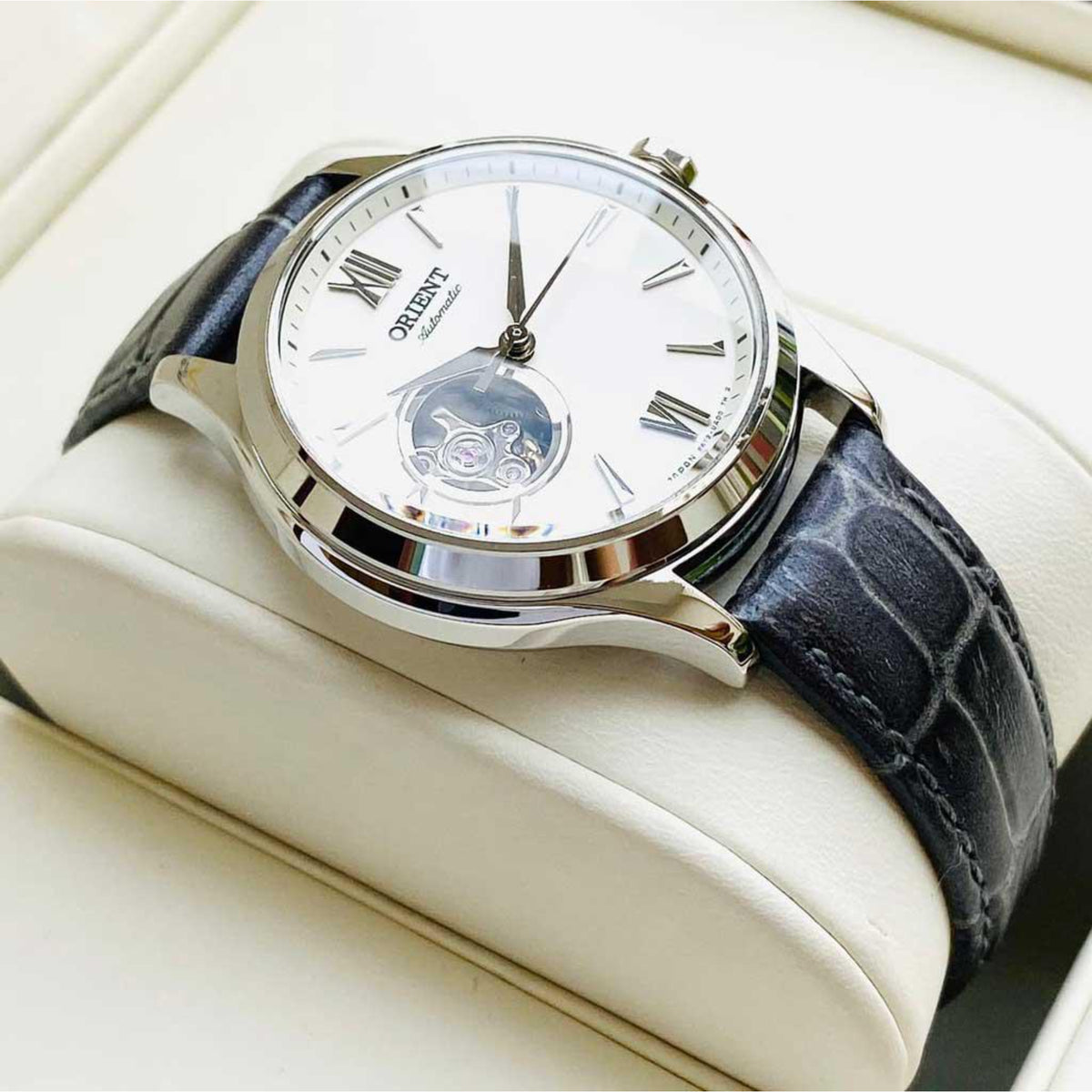 Orient automatic watch with white dial and black leather strap