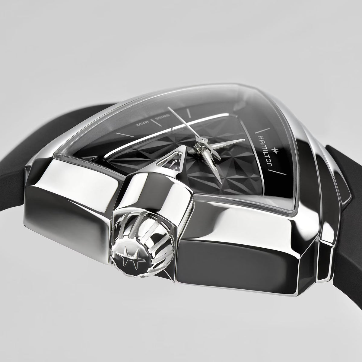 Ventura quartz wristwatch close-up with geometric black dial, silver-toned case, black rubber strap