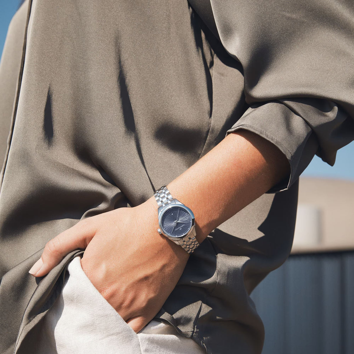 Hamilton Jazzmaster steel quartz watch with blue dial on a person’s wrist