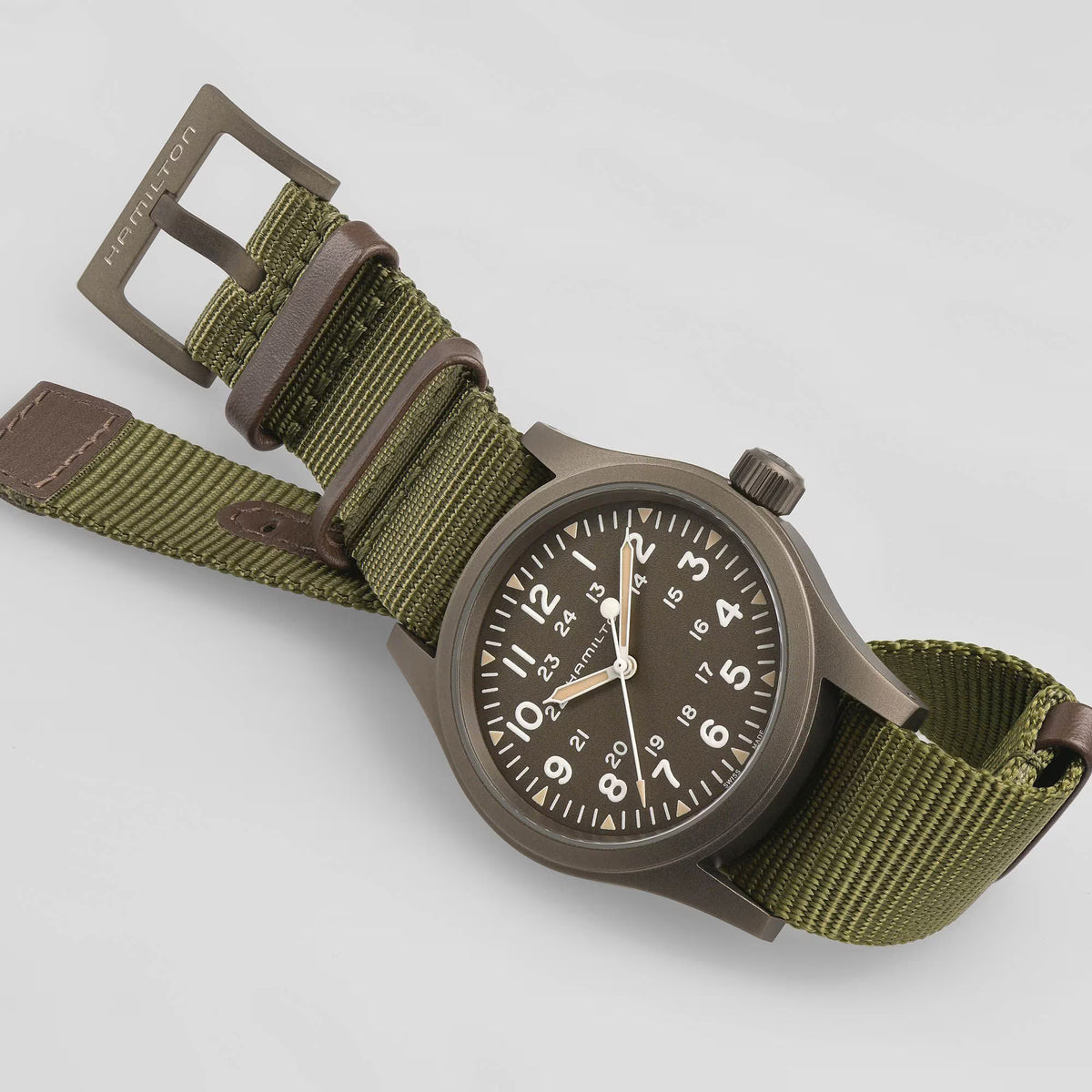 Men's mechanical field watch on olive NATO strap with round dark case and crown