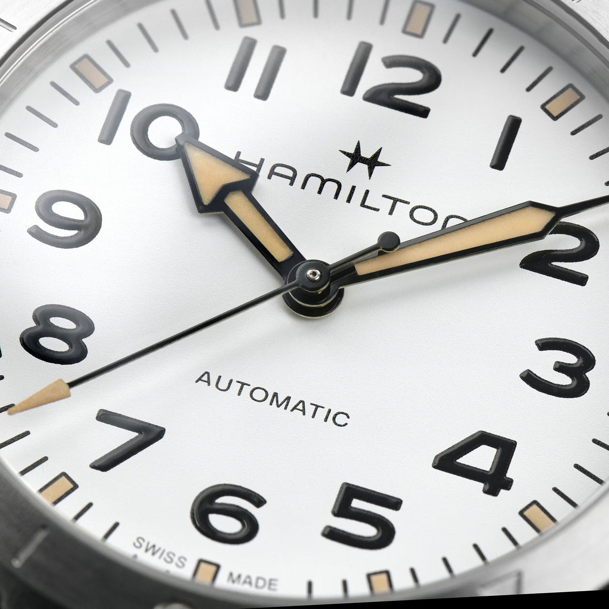 Hamilton H70225110 white dial with Arabic numerals and compass-style bezel close-up