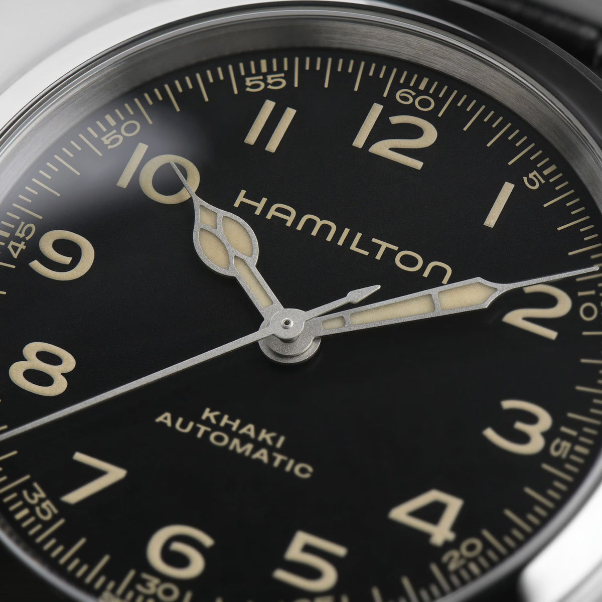 Hamilton Khaki Field Murph H70405730 38mm mens watch close-up head detail focusing on black dial with cathedral hands and vintage-toned numerals