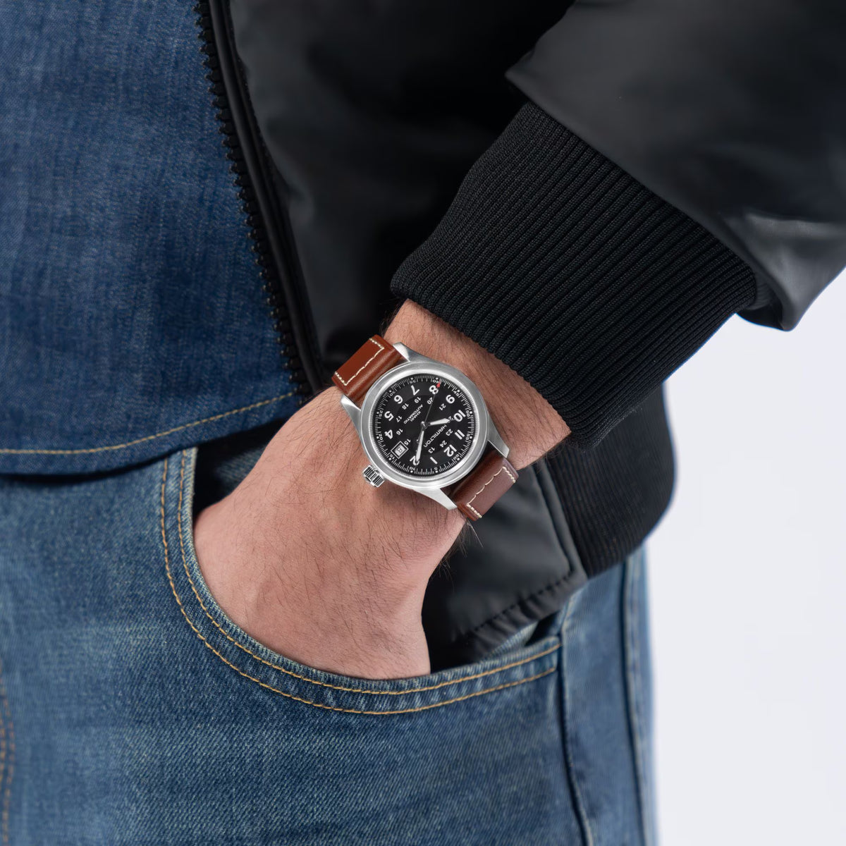 Hamilton Khaki Field H70455533 automatic timepiece worn on a wrist with denim jacket attire