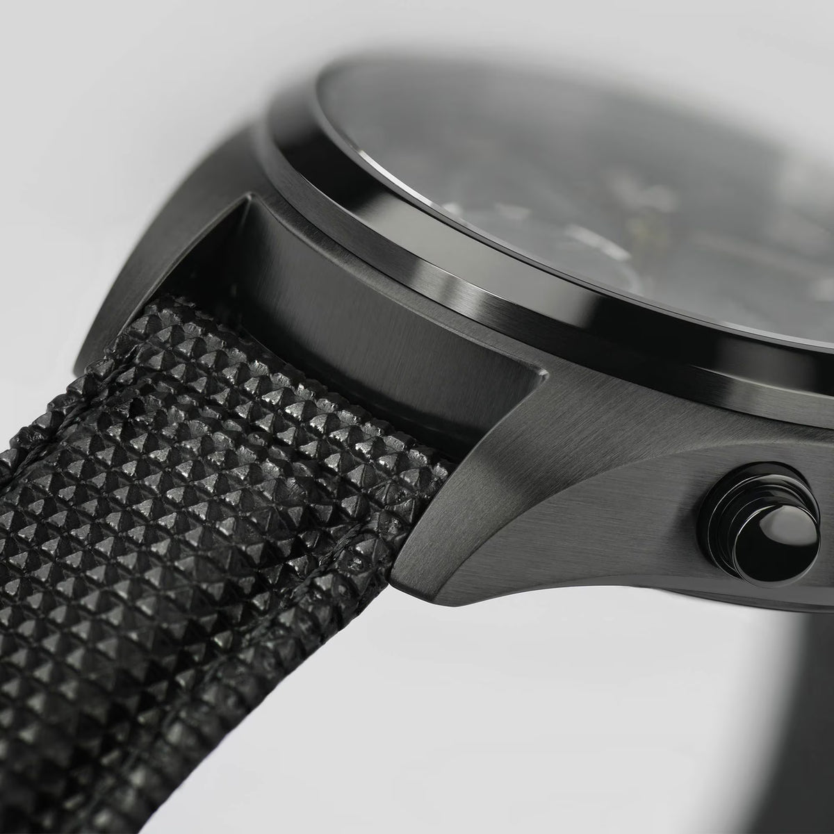 Hamilton Khaki Field H71626735 close-up profile view highlighting the brushed finish of the black case and the strap lug connection